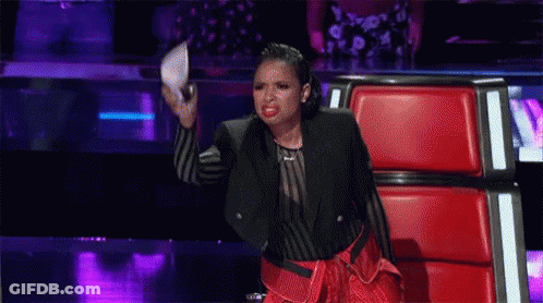 Woman On Stage In Red Chair Holding Microphone GIF
