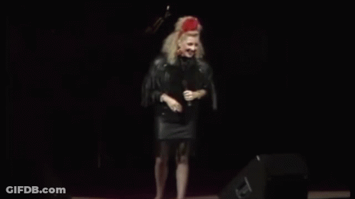 Woman On Stage With Guitar And Stool GIF