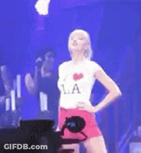 Woman On Stage With Hands On Hips Wearing LA Shirt GIF