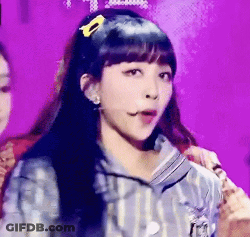 Woman On Stage With Yellow Hair Clip GIF