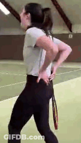 Woman On Tennis Court Holding Tennis Racquet GIF