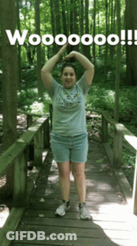 Woman On Wooden Bridge Arms Up Wooooo GIF