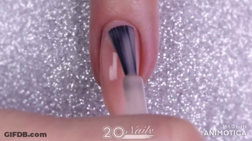Woman Painting Nails With Brush On Glittery Surface GIF
