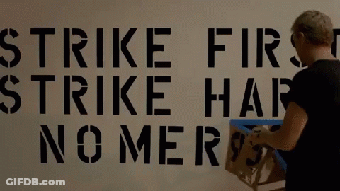 Woman Paints Strike First Strike Hard No Mercy GIF