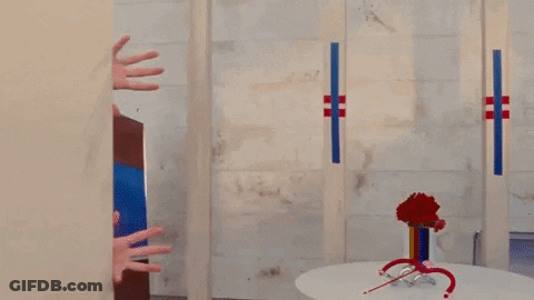 Woman Peeking Behind Bathroom Wall GIF