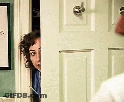 Woman Peeking From Behind Door With Picture GIF