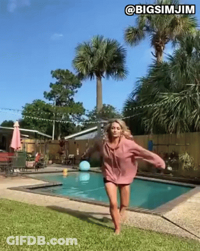 Woman Peeking From Behind Wall GIF