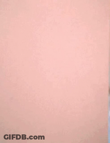 Woman Peeking From Behind Wall GIF