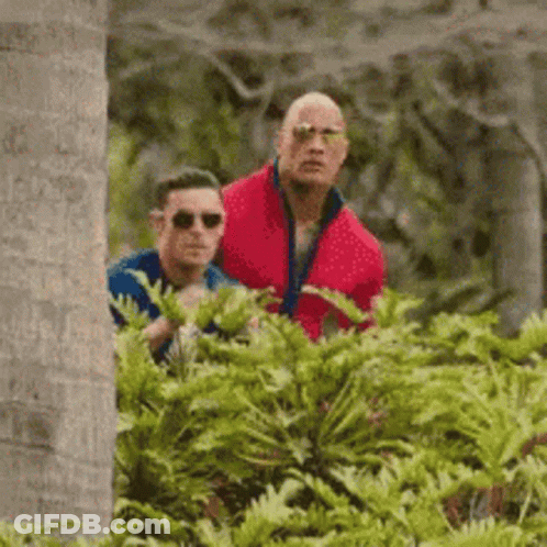 Woman Peeking Out From Behind Tree GIF