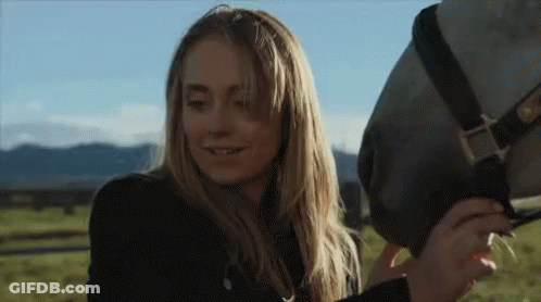 Woman Petting Horse In Field GIF