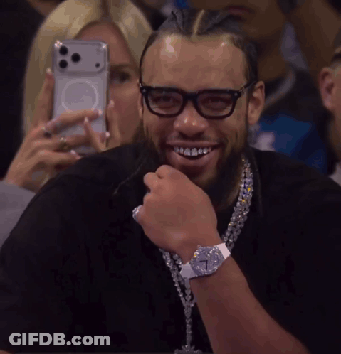 Woman Photographing Man With Glasses And Cross Necklace GIF