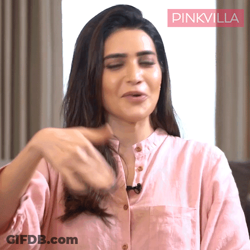 Woman Pink Shirt Playing With Hair Pink Villa Sign GIF