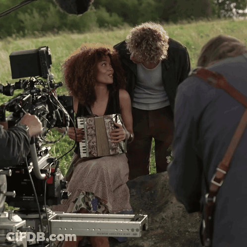 Woman Playing Accordion In Front Of North America Camera GIF