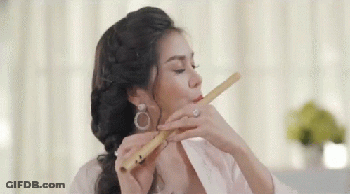 Woman Playing Flute Eyes Closed Earrings GIF