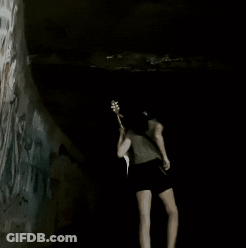Woman Playing Guitar In Dark Room GIF