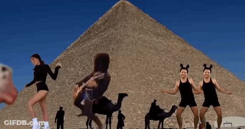 Woman Playing Guitar In Front Of Pyramid GIF