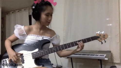 Woman Playing Guitar Near Keyboard GIF