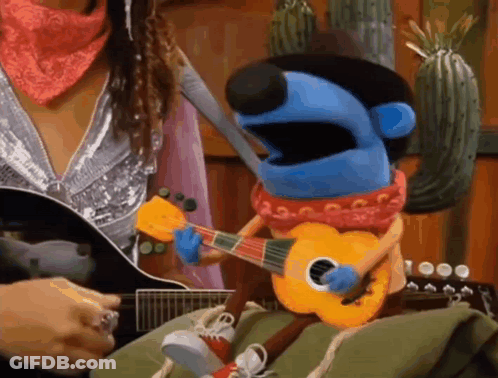 Woman Playing Guitar Next To Puppet Playing Guitar GIF