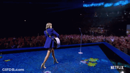 Woman Playing Guitar On Stage With Netflix GIF