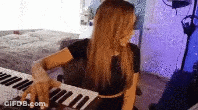 Woman Playing Keyboard In Purple Lights GIF