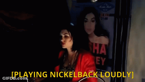 Woman Playing Nickelback Loudly In Front Of Poster GIF