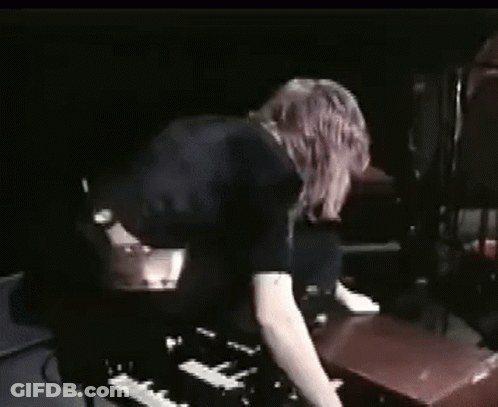 Woman Playing Piano In Dark Room GIF