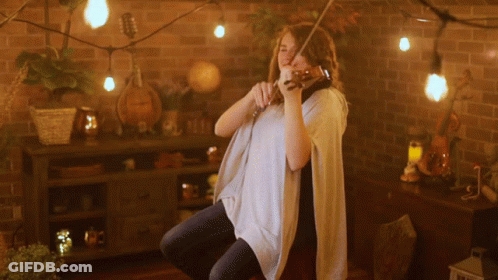 Woman Playing Violin With String Lights GIF