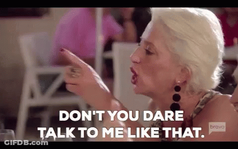 Woman Pointing At Another While Talking GIF