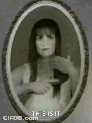 Woman Pointing At Herself In Mirror GIF