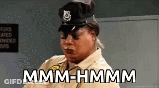 Woman Police Uniform Saying Mmmm Hmmm GIF