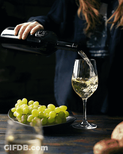 Woman Pouring Wine From S.A. Bottle GIF