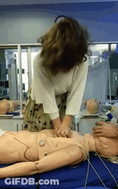 Woman Practicing On Mannequin With Clock GIF