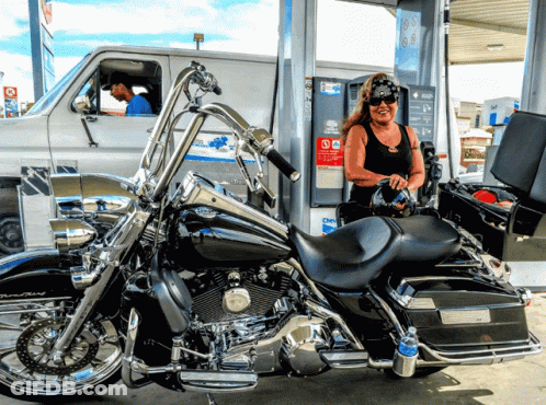 Woman Pumping Gas Into Harley Davidson Motorcycle GIF