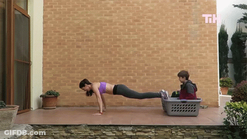 Woman Push Ups Near Laundry Basket GIF