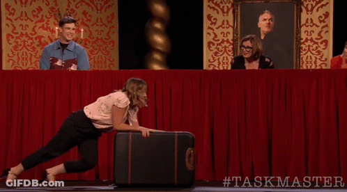 Woman Pushing Suitcase With #Taskmaster GIF