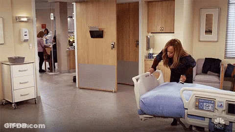 Woman Putting Blanket On Hospital Bed GIF