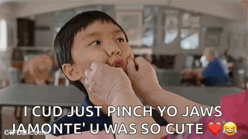 Woman Putting Hand On Boy's Face Making Funny Face GIF