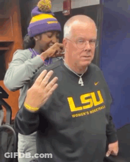 Woman Putting Necklace On Man In LSU Basketball Sweatshirt GIF