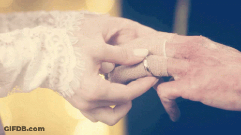Woman Putting Wedding Ring On Man's Finger GIF