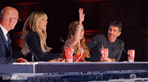 Woman Raising Hand At Table GIF