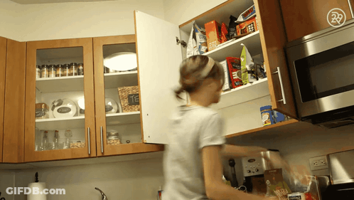 Woman Reaching For Nescafe Coffee In Cupboard GIF