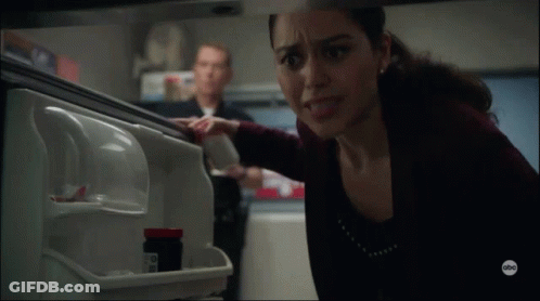 Woman Reaching Into Refrigerator With Pills GIF
