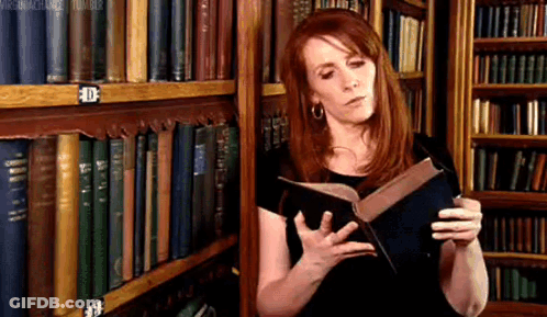 Woman Reading Book In Library GIF