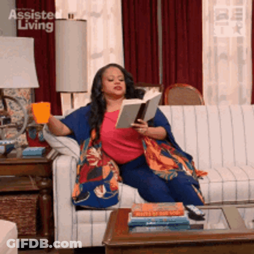 Woman Reading Book On Couch GIF
