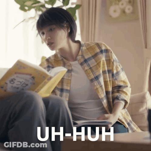 Woman Reading Book Saying Uh-Huh GIF