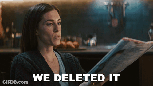 Woman Reading Newspaper Saying We Deleted It GIF