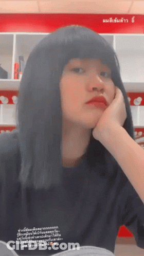 Woman Resting Head On Hand In Front Of Sign Saying A GIF