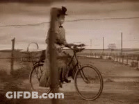 Woman Riding Bicycle On Dirt Road Black And White GIF