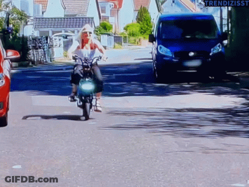 Woman Riding Motorcycle Next To Blue Van And Red Car GIF