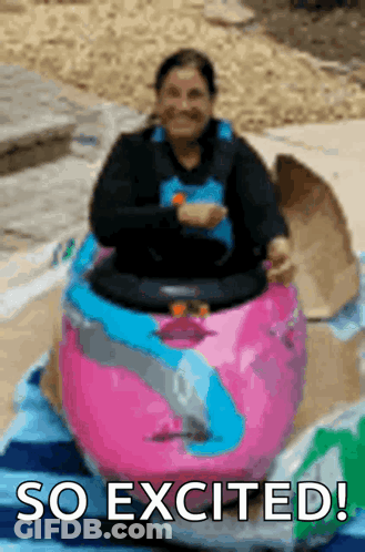 Woman Riding Pink And Blue Toy Car Saying So Excited GIF